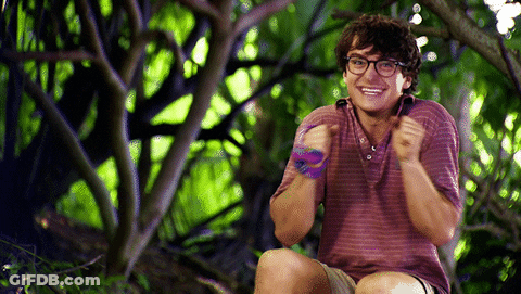 Young Man With Glasses Smiling In Woods GIF