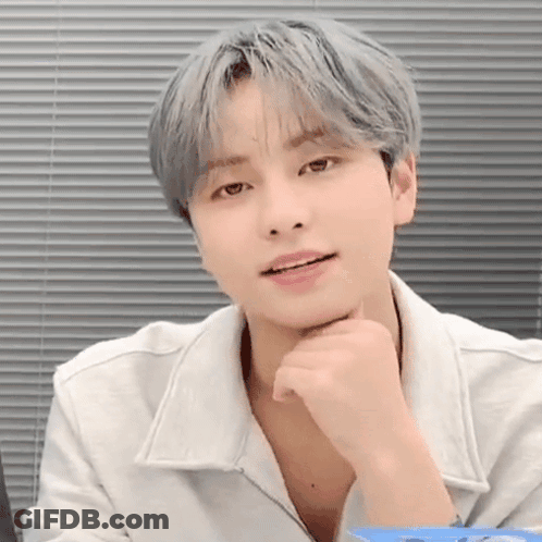 Young Man With Gray Hair Sitting By Window GIF