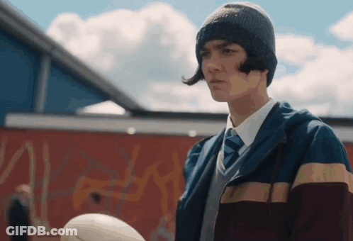 Young Man With Hat Tie Holding Rugby Ball GIF