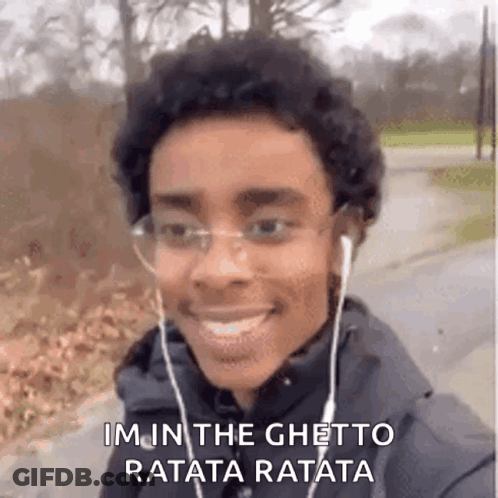 Young Man With Headphones And Glasses Smiling While Walking GIF
