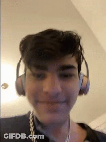 Young Man With Headphones And Rope Around Neck Smiling GIF