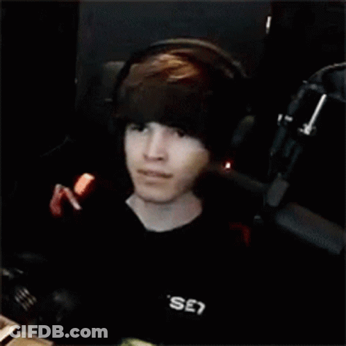 Young Man With Headphones At Microphone In Dark Room GIF