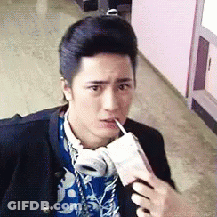 Young Man With Headphones Drinking From Cup GIF