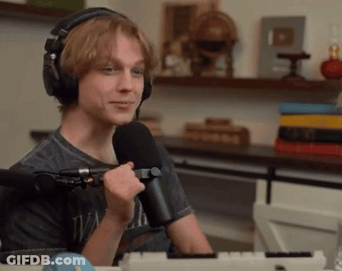 Young Man With Headphones Holding Microphone GIF