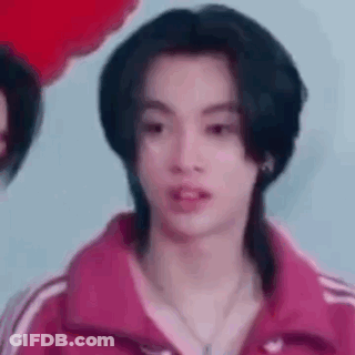 Young Man With Long Black Hair In Pink Jacket And Necklace GIF