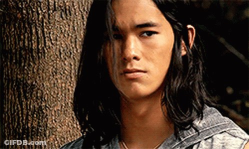 Young Man With Long Black Hair Next To Tree GIF