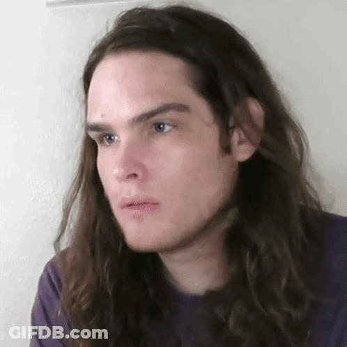 Young Man With Long Hair And Purple Shirt GIF