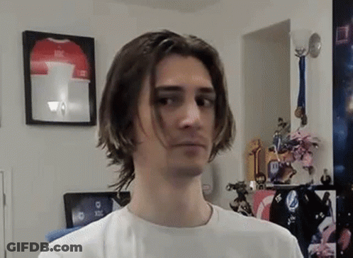 Young Man With Long Hair Standing By Framed Jersey GIF