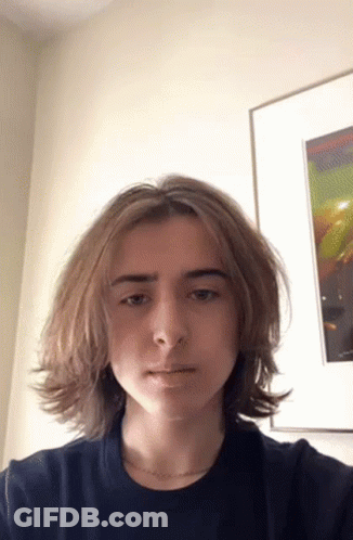 Young Man With Long Hair Taking Selfie GIF