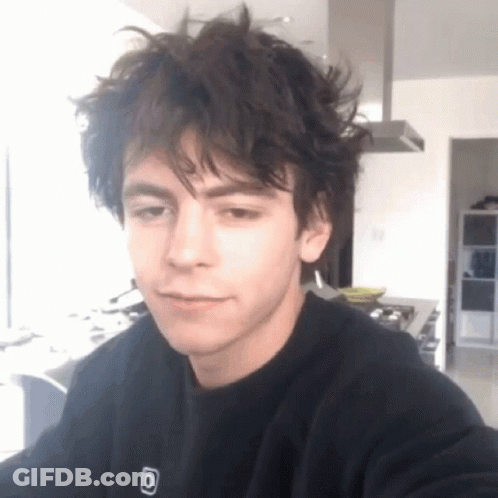 Young Man With Messy Hair In Black Sweatshirt With Letter O GIF