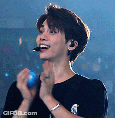Young Man With Microphone And Bracelet Clapping GIF