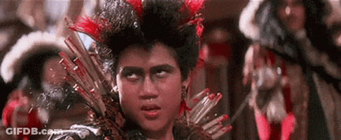 Young Man With Mohawk And Feathers Holding Spear GIF