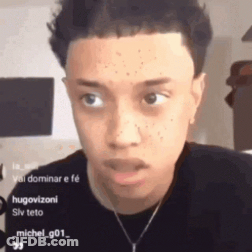 Young Man With Necklace Looking At Camera GIF
