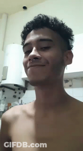 Young Man With Nose Ring Smiling In Kitchen GIF