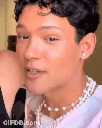 Young Man With Pearl Necklace And Earrings GIF