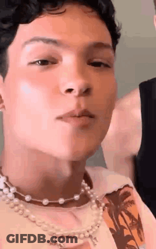 Young Man With Pearl Necklace And Nose Ring GIF