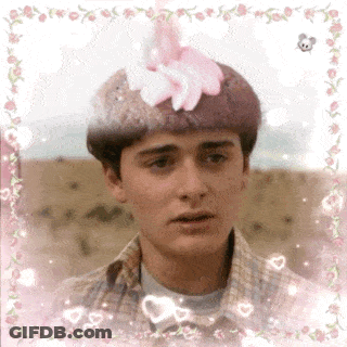 Young Man With Pink Flower On Head GIF