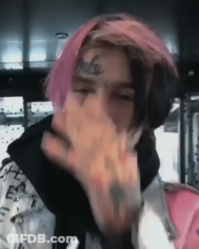 Young Man With Pink Hair And Face Tattoo Covering Mouth GIF