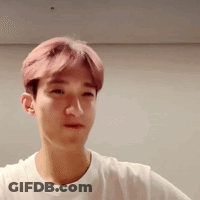 Young Man With Pink Hair In White T-Shirt Looking At Camera GIF