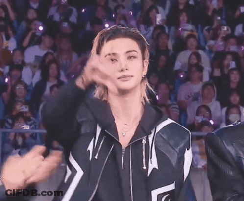 Young Man With Ponytail Giving Peace Sign GIF