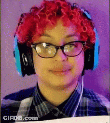 Young Man With Red Curly Hair And Glasses Wearing Headphones GIF