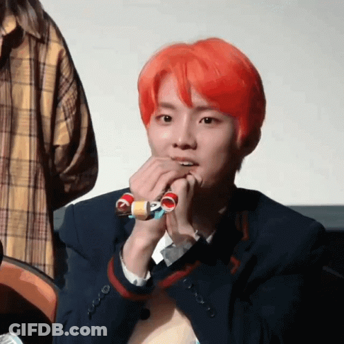Young Man With Red Hair Holding Toy GIF