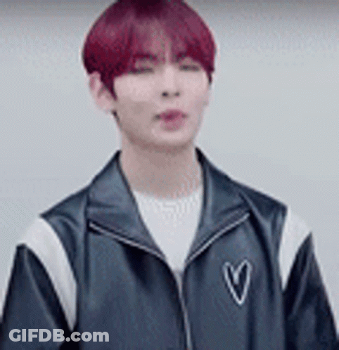 Young Man With Red Hair In Black Jacket With Heart GIF