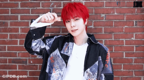 Young Man With Red Hair In Front Of Brick Wall GIF