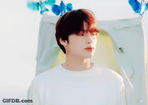 Young Man With Red Hair In Front Of Tent With Blue Butterflies GIF