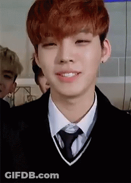 Young Man With Red Hair In Sweater Vest And Tie GIF