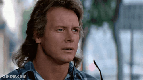 Young Man With Red Hair In Sweater Vest And Tie GIF