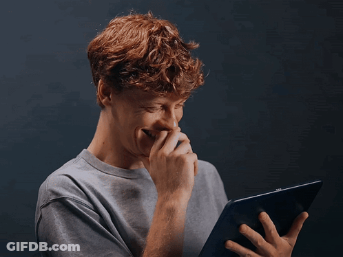 Young Man With Red Hair Laughing Holding Tablet GIF
