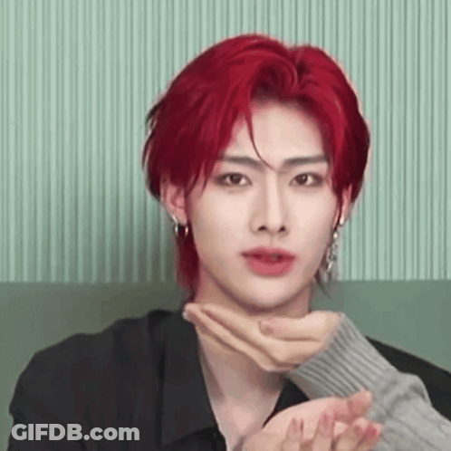 Young Man With Red Hair Sitting On Couch Hands On Neck GIF
