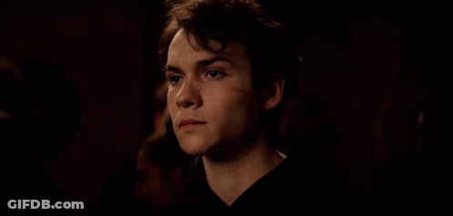 Young Man With Scar On Face Looking Down GIF
