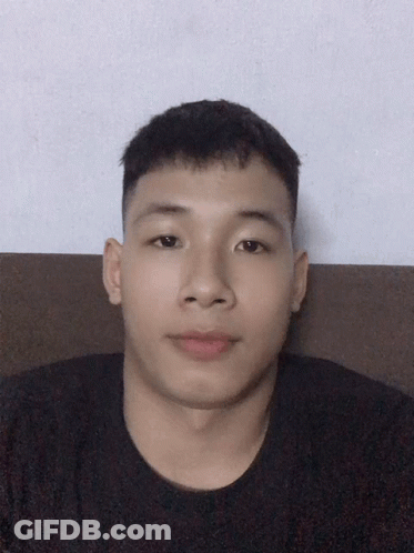 Young Man With Short Hair Sitting On Couch GIF