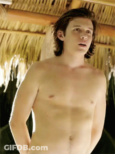 Young Man Without Shirt In Front Of Thatched Roof GIF