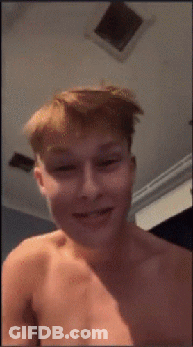 Young Man Without Shirt Smiling In Front Of Ceiling Fan GIF