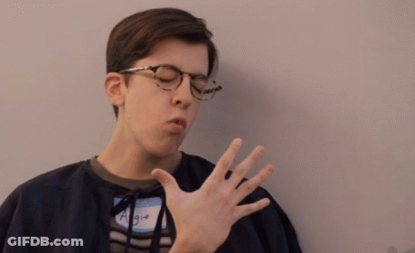 Young Man Yawning With Glasses And Name Tag GIF