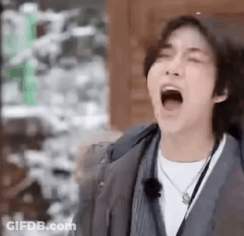 Young Man Yawns In Jacket Necklace GIF