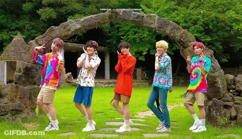 Young Men By Stone Archway In Field GIF
