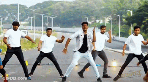 Young Men Dancing In Front Of Aditya Sign GIF