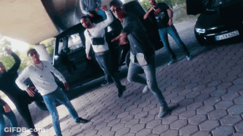 Young Men Dancing In Front Of Black Car GIF