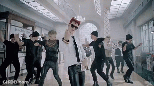 Young Men Dancing In Front Of Exchange Sign GIF