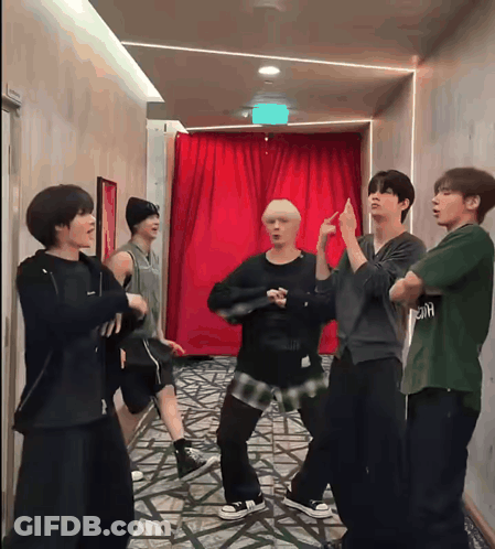 Young Men Dancing In Hallway Under Exit Sign GIF