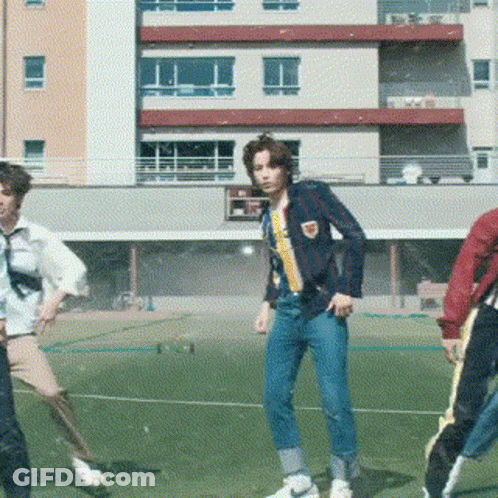 Young Men Dancing On Soccer Field In Front Of Building GIF