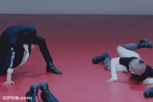 Young Men Doing Handstands On Red Floor Saying Haha GIF