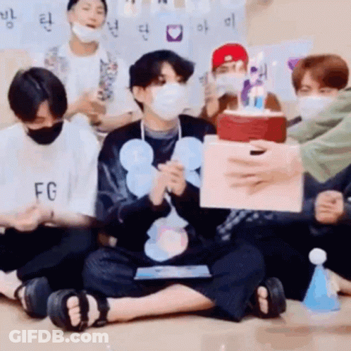 Young Men In Face Masks Holding Birthday Cake GIF