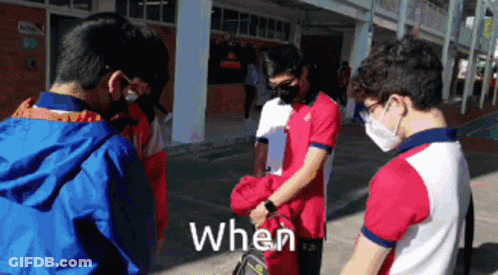 Young Men In Face Masks Standing In Front Of Building Saying When GIF