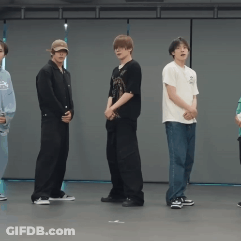 Young Men In Row, One Wearing White Adidas Shirt GIF