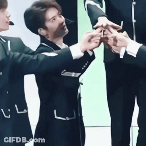Young Men In Suits Standing Together GIF